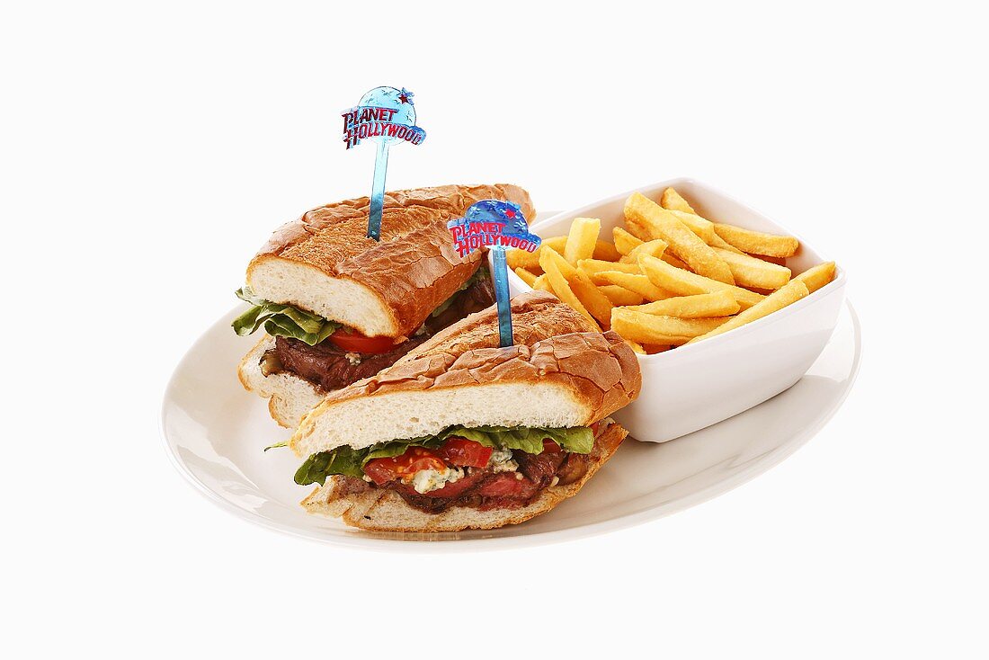 Steak sandwich with dish of chips