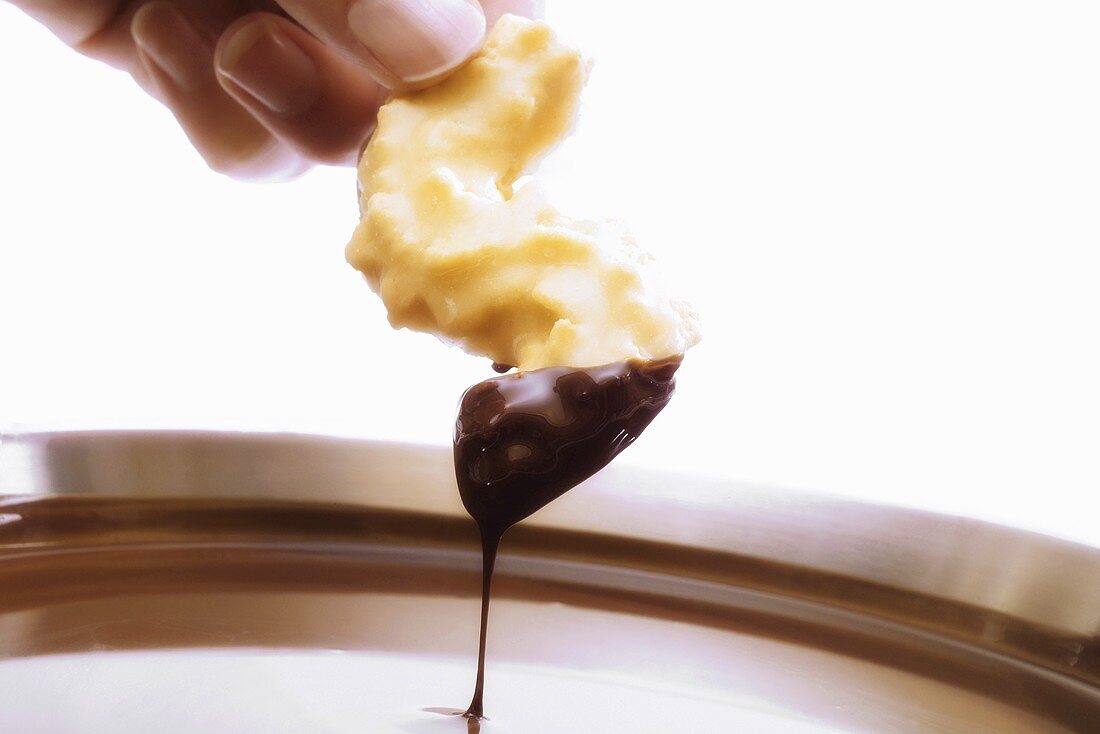 Dipping a cookie in couverture chocolate