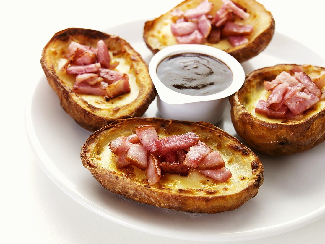 Baked potatoes with cheese, ham and dip