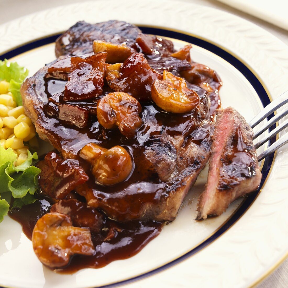 Steak with Bacon Mushroom Sauce; Piece on a Fork