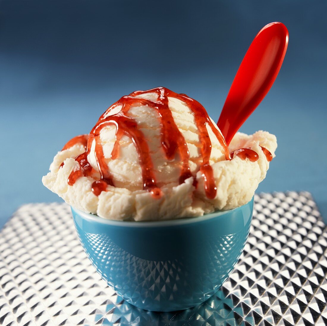 Single Scoop of Vanilla Ice Cream with Strawberry Sauce; In Bowl with Spoon