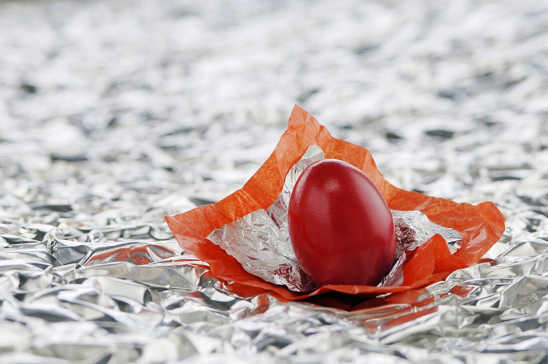 Red egg in silver foil