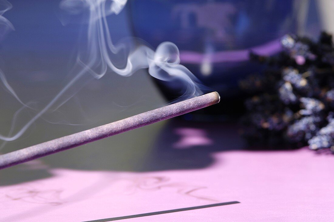 Incense stick with lavender flowers, close-up
