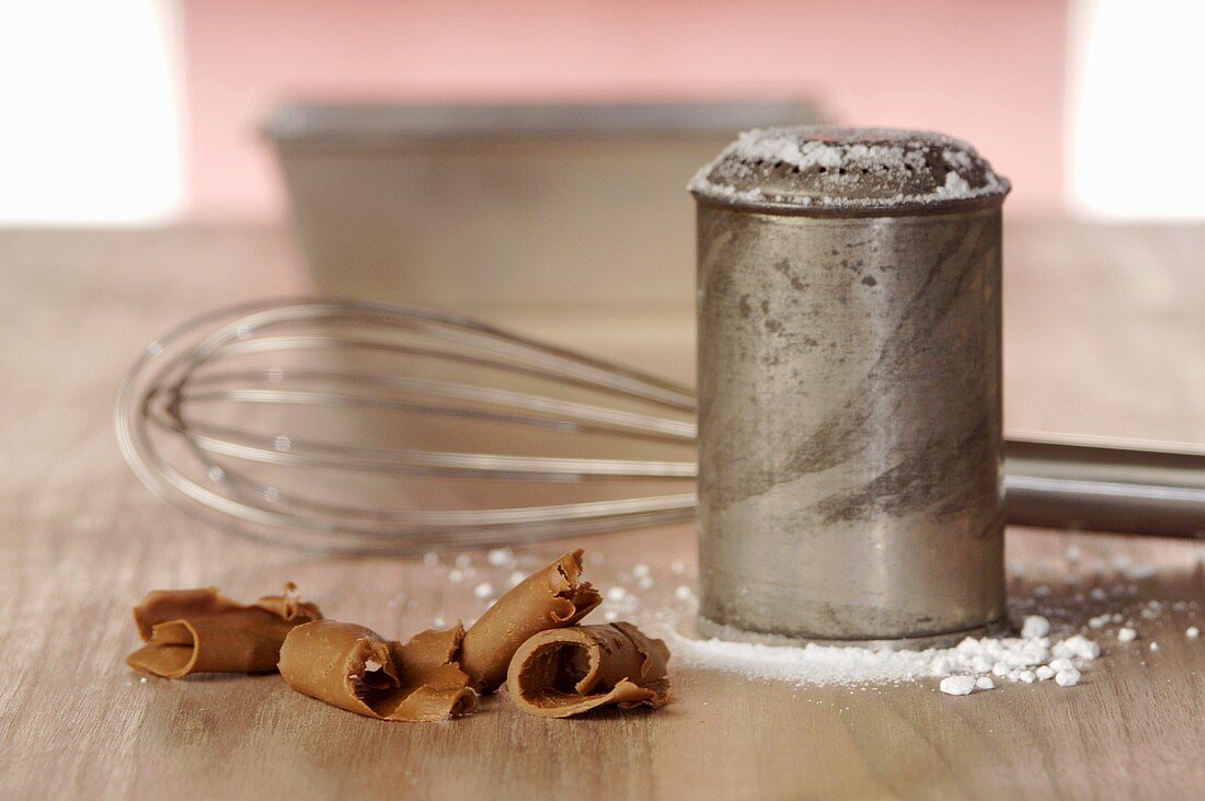 Gianduja curls, sugar sifter and whisk