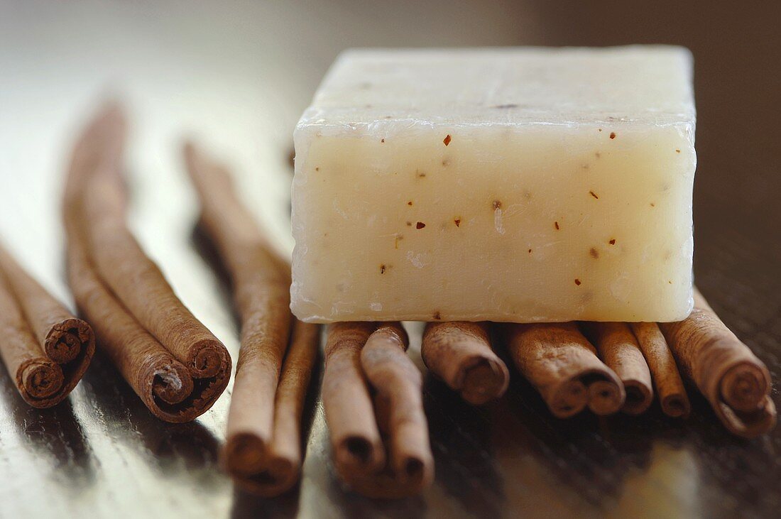 Bar of flavour soap on cinnamon sticks, close-up