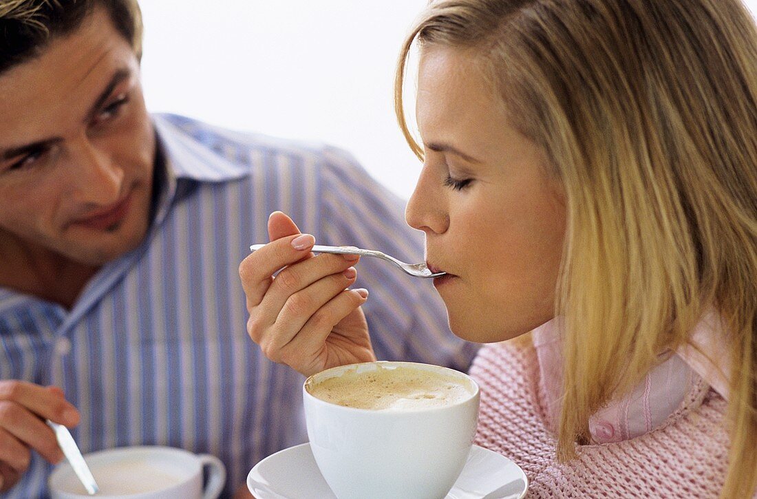 Young couple drinking coffee and tea