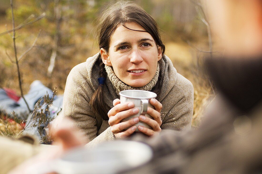 Austria, Salzburg County, Young woman holding a cup