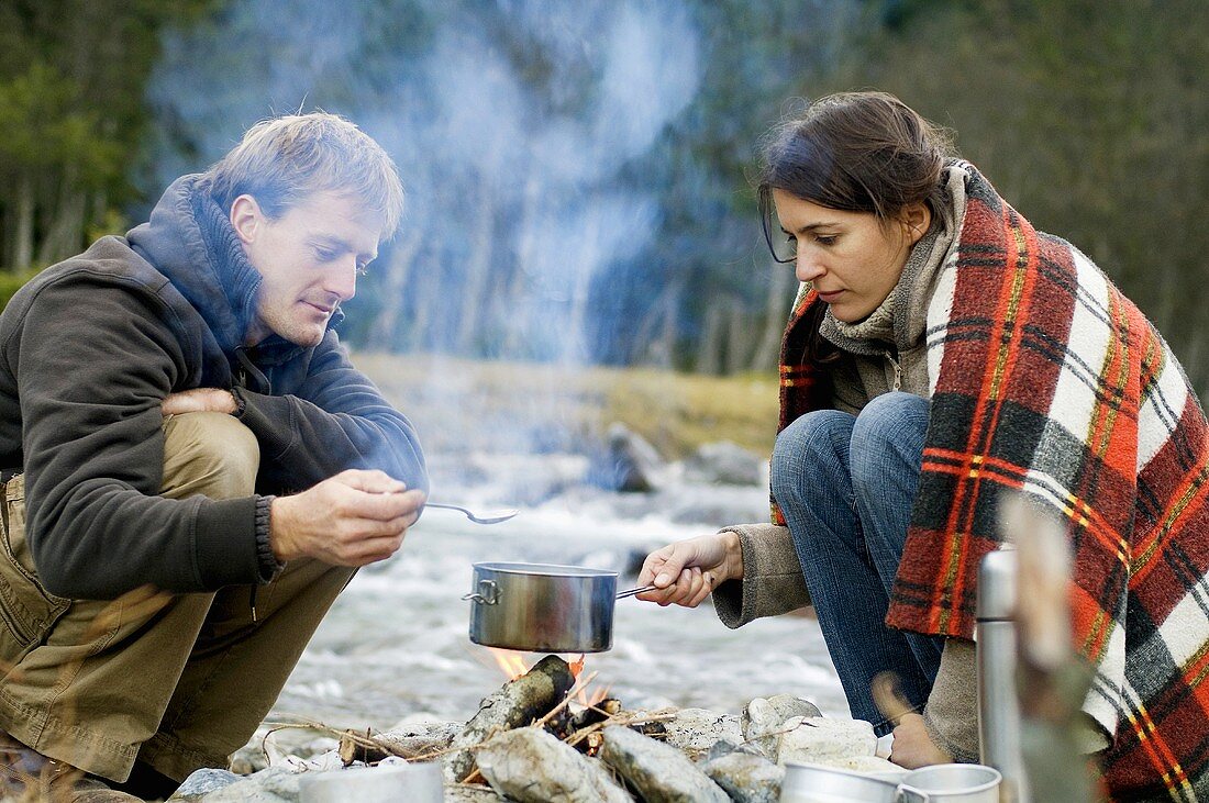 Austria, Salzburg County, Young couple at campfire