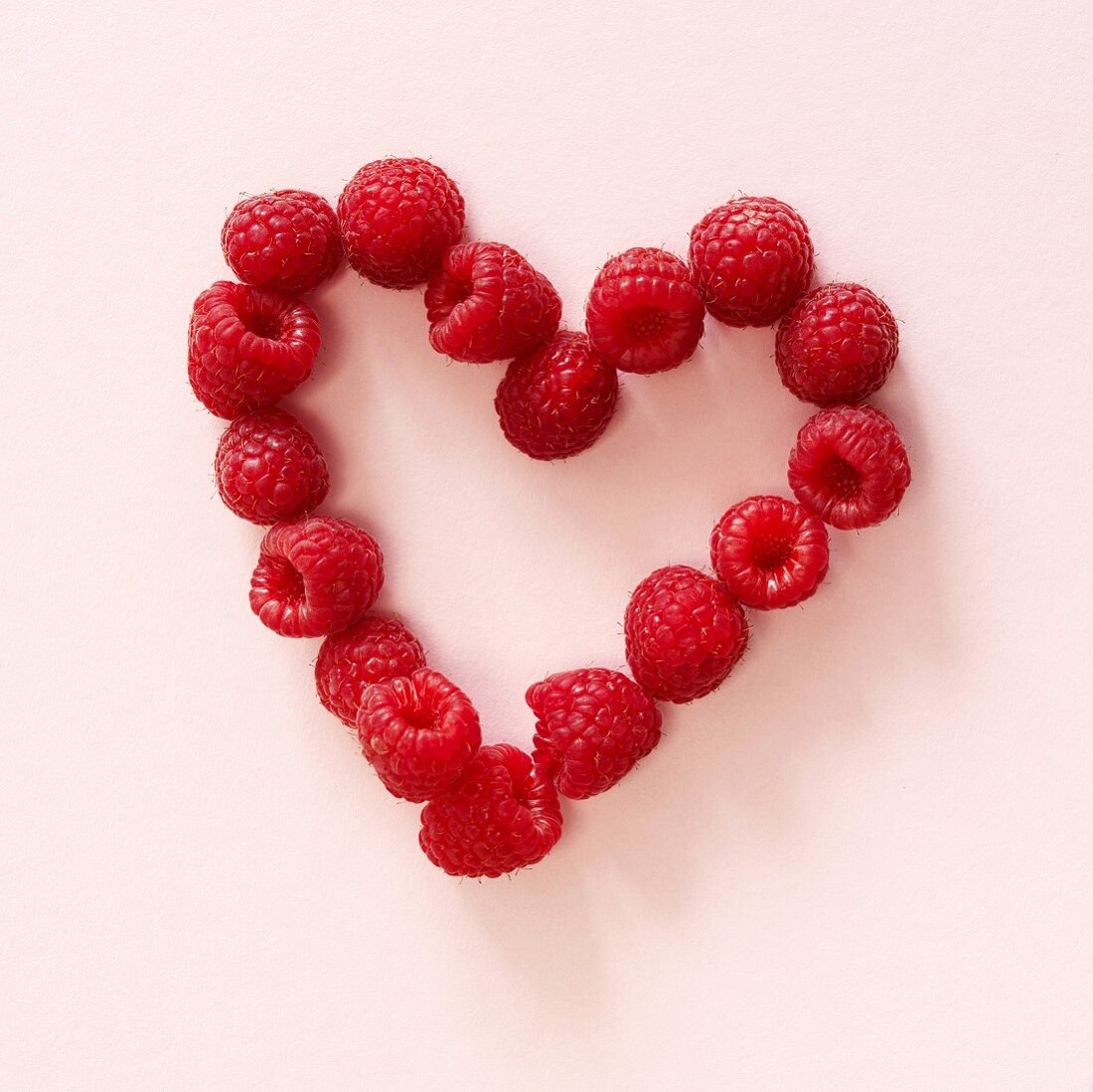 Fresh raspberries forming a heart