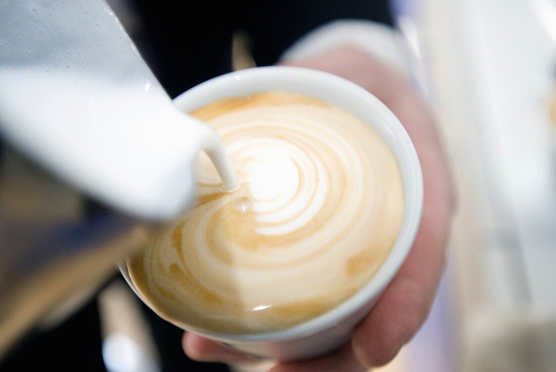 Making cappuccino with frothed milk