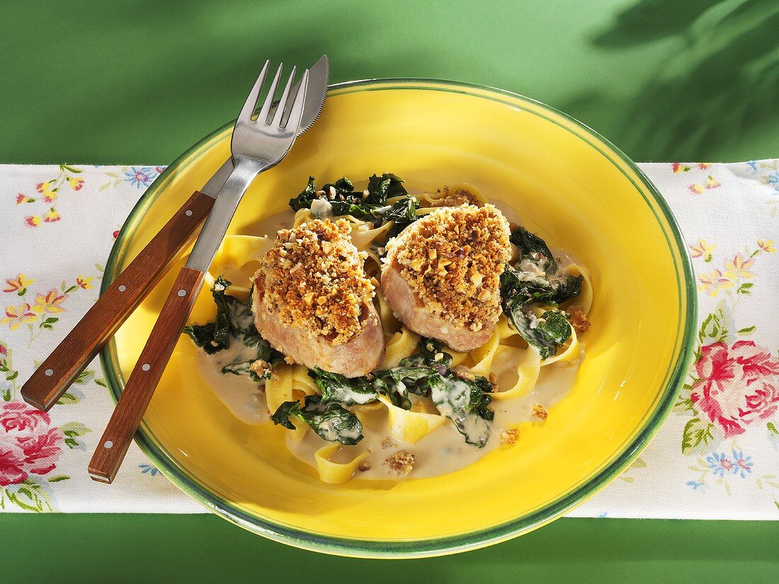 Pork fillet with nut crust, spinach, pasta and Gorgonzola sauce