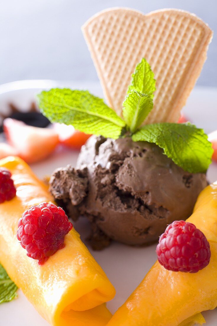 Chocolate ice cream with pancakes, raspberries and wafer