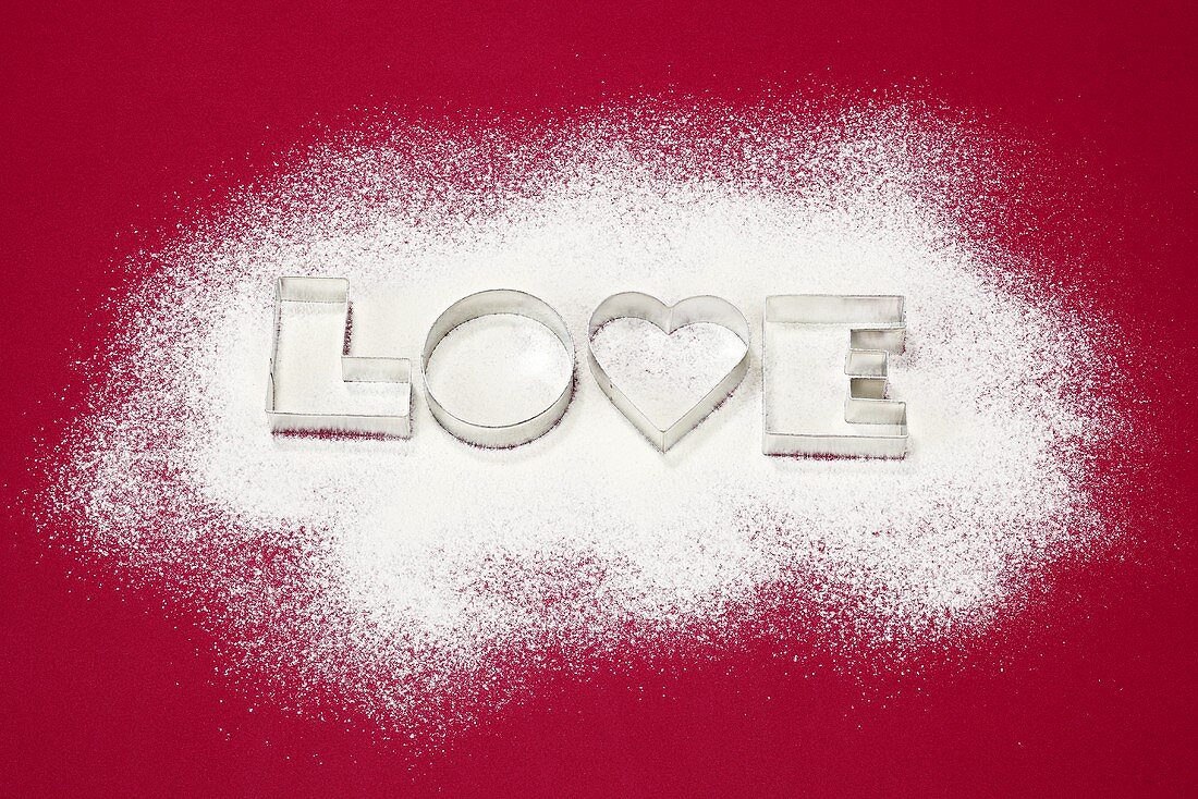 Biscuits cutters for 'LOVE' biscuits on icing sugar