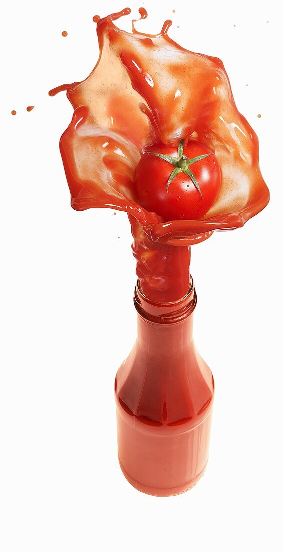 Tomato ketchup splashing out of bottle