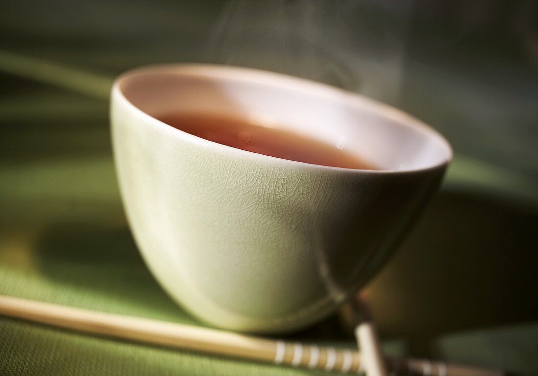 Bowl of tea and chopsticks