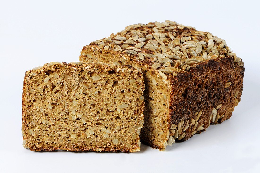 Whole-grain bread with sunflower seeds, partly sliced
