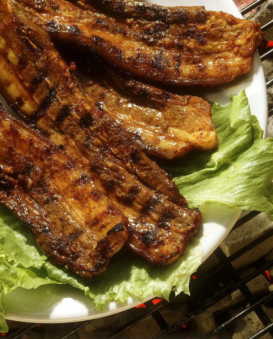 Barbecued ribs on bed of lettuce