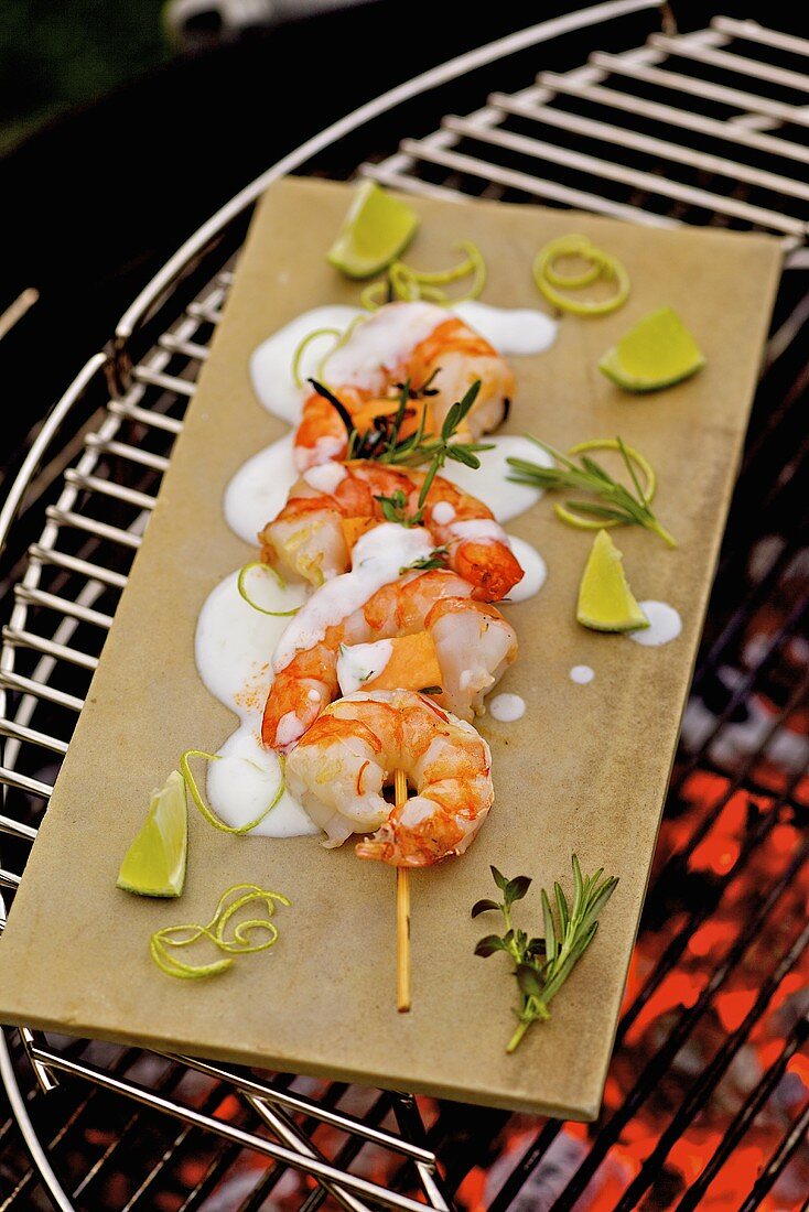 Barbecued prawn skewers with melon and lime yoghurt