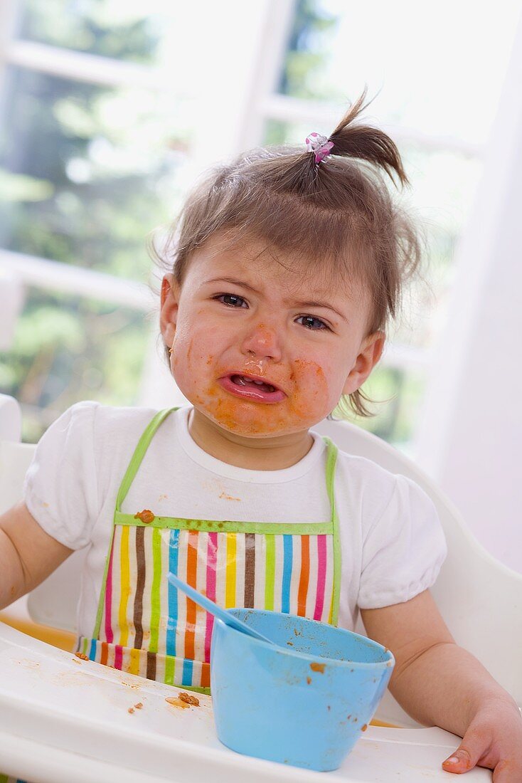 Girl eating pasta with bolognese sauce