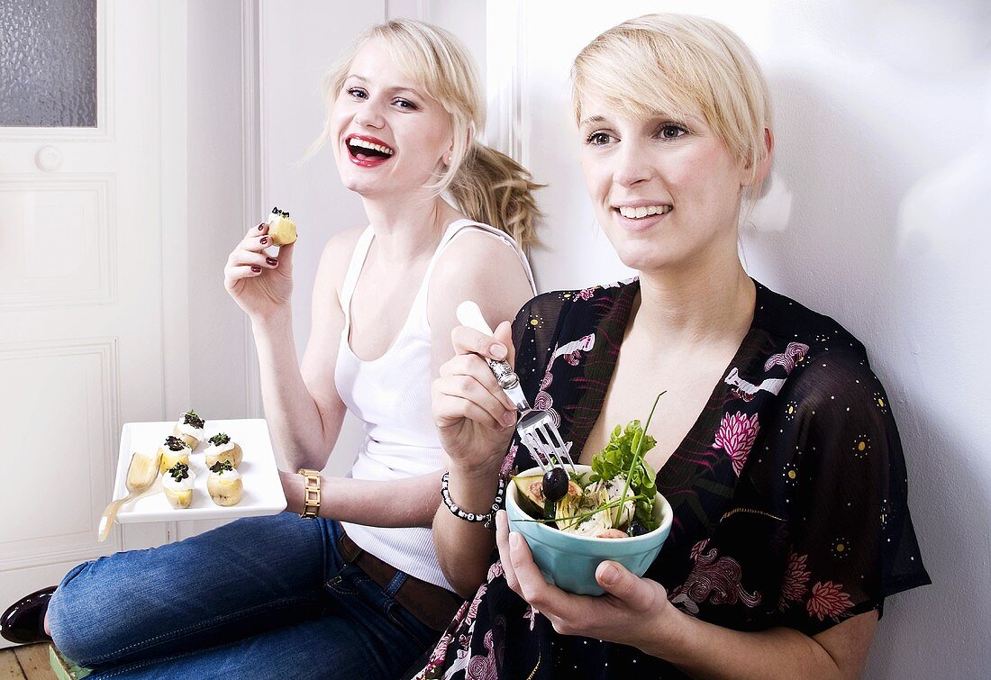 Two women eating appetisers