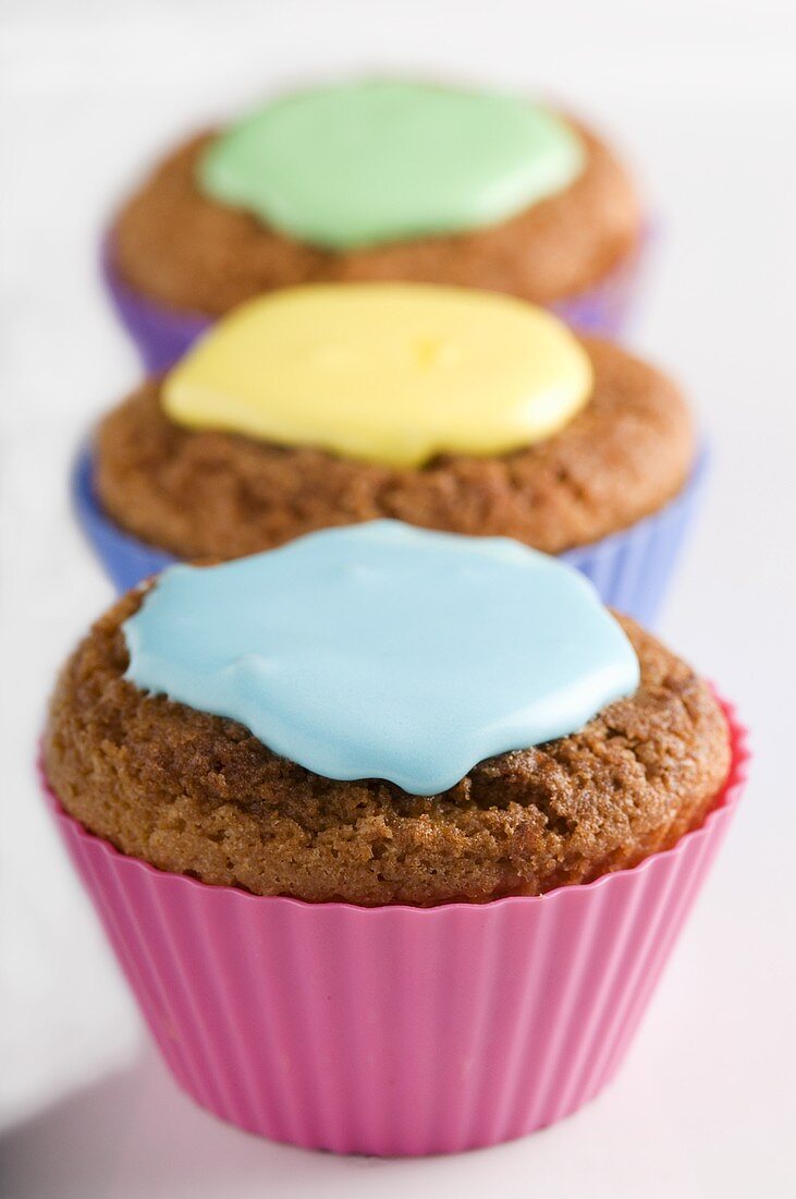 Three cupcakes with different coloured icing