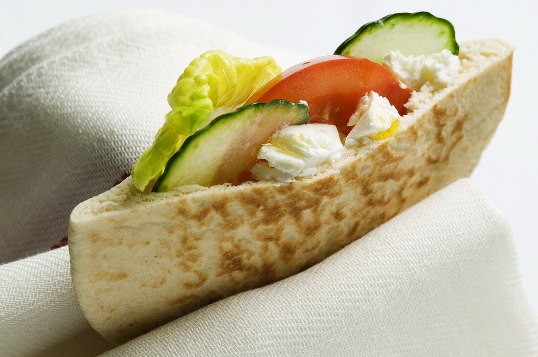 Pita bread filled with soft cheese and vegetables