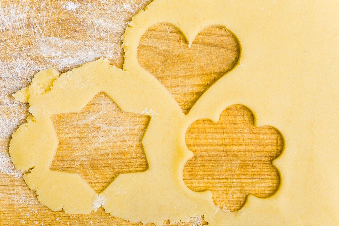 Biscuit dough with the shapes of cut-out biscuits