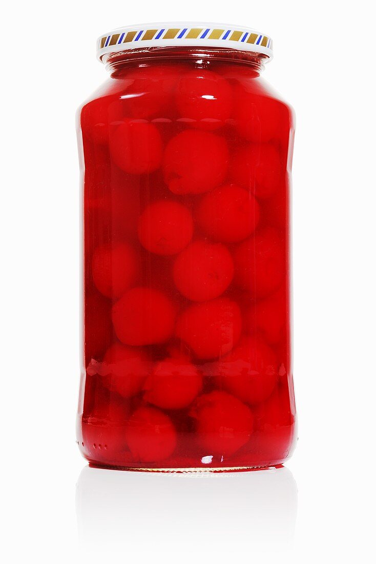 A jar of bottled cherries