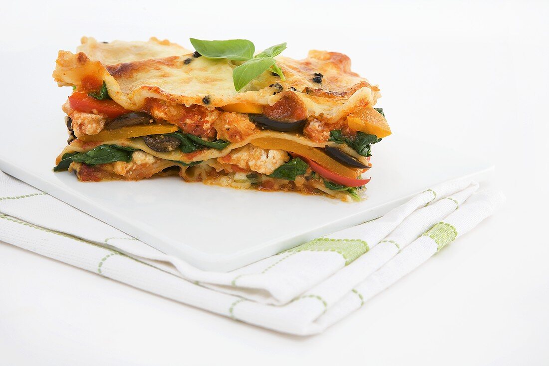 Vegetable lasagne on chopping board