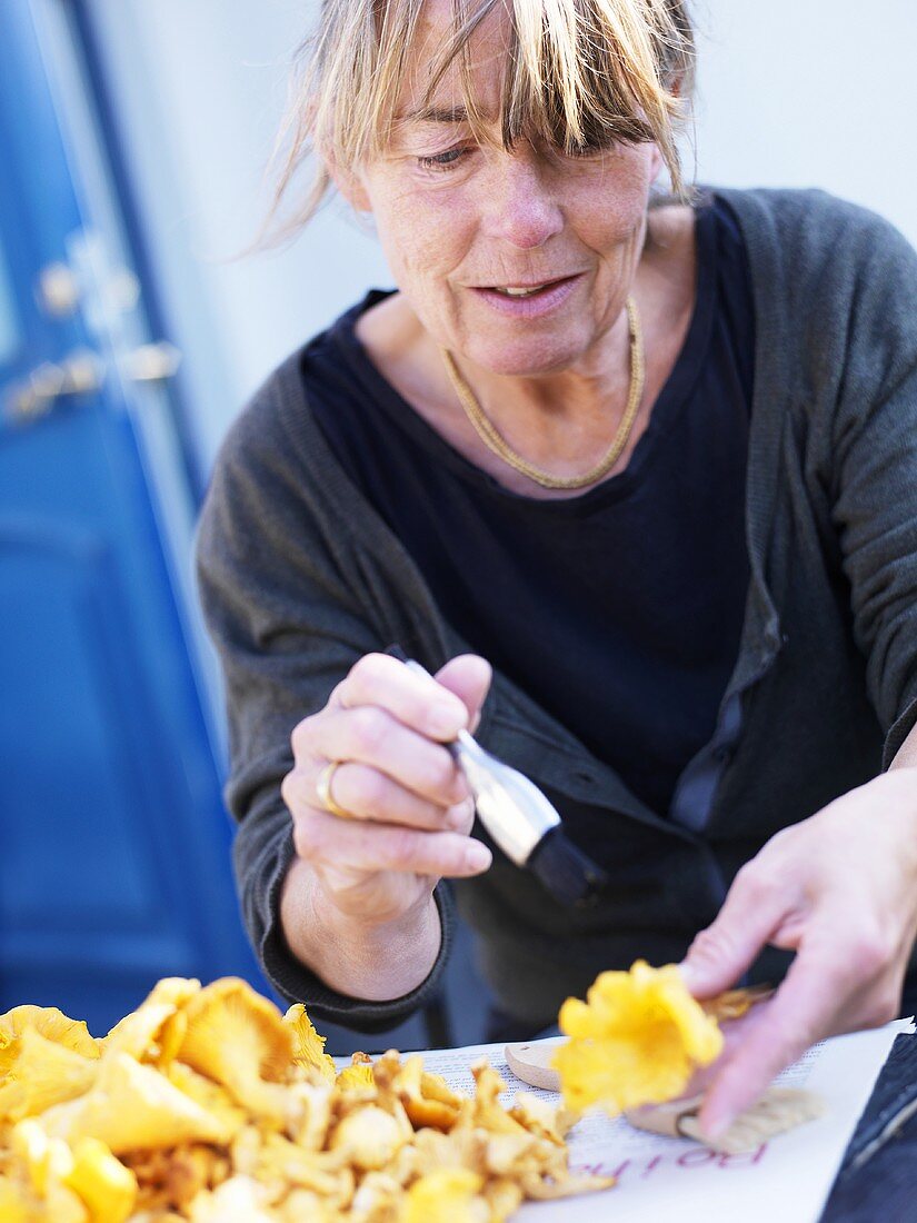 Woman cleaning chanterelles