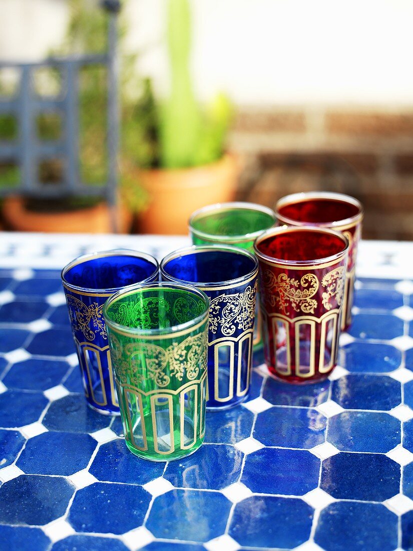 Several coloured glasses on mosaic table