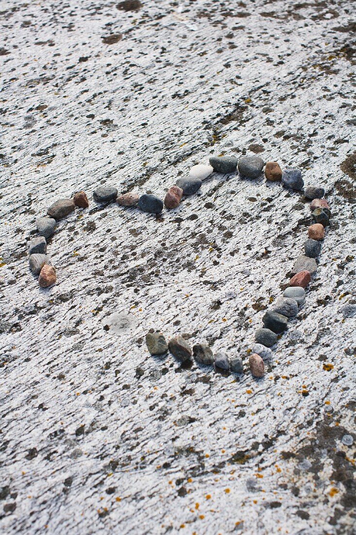 Heart made of pebbles on the beach