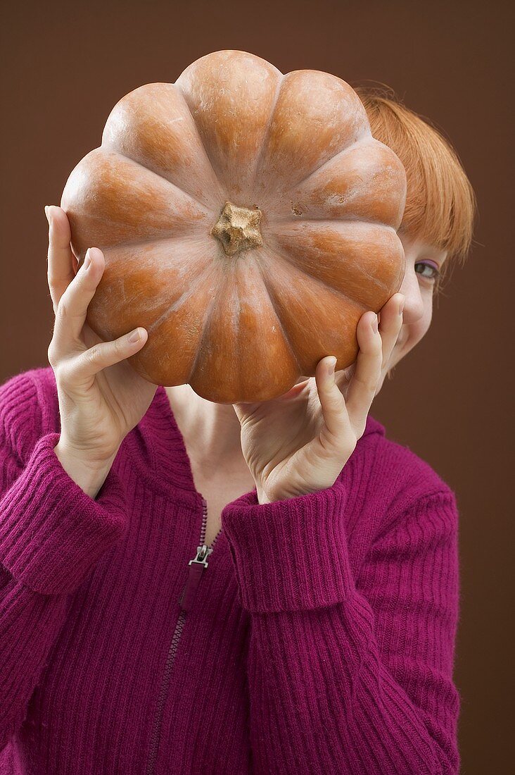 Frau hält Moschuskürbis