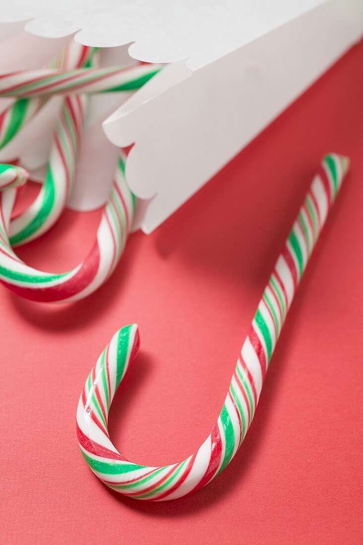 Candy canes in and beside paper bag