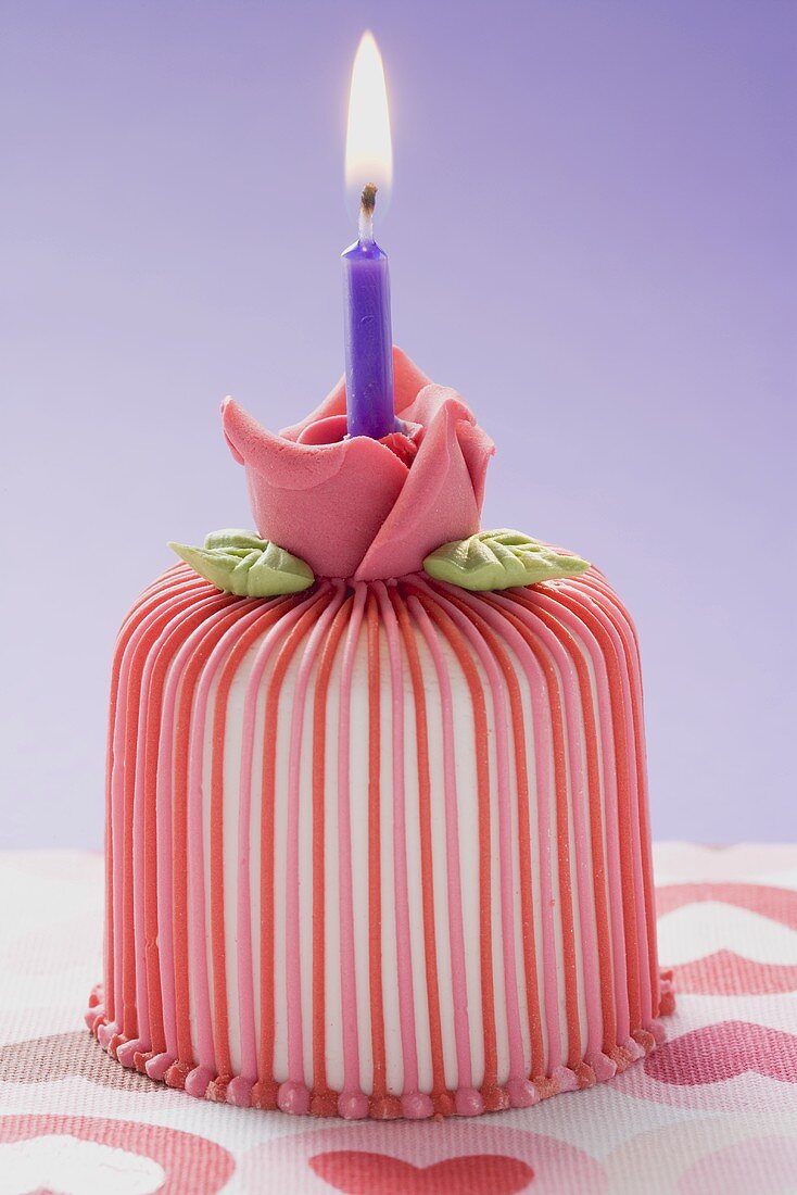 Marzipan-covered cake with candle
