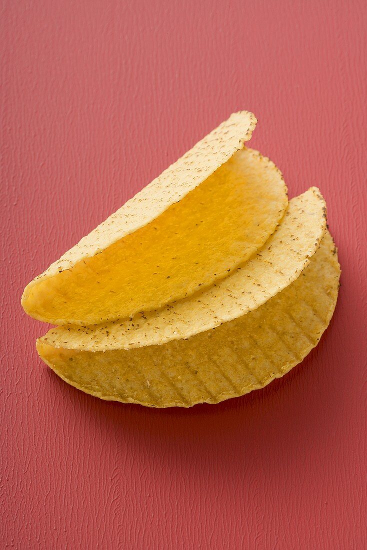 Two taco shells on red background