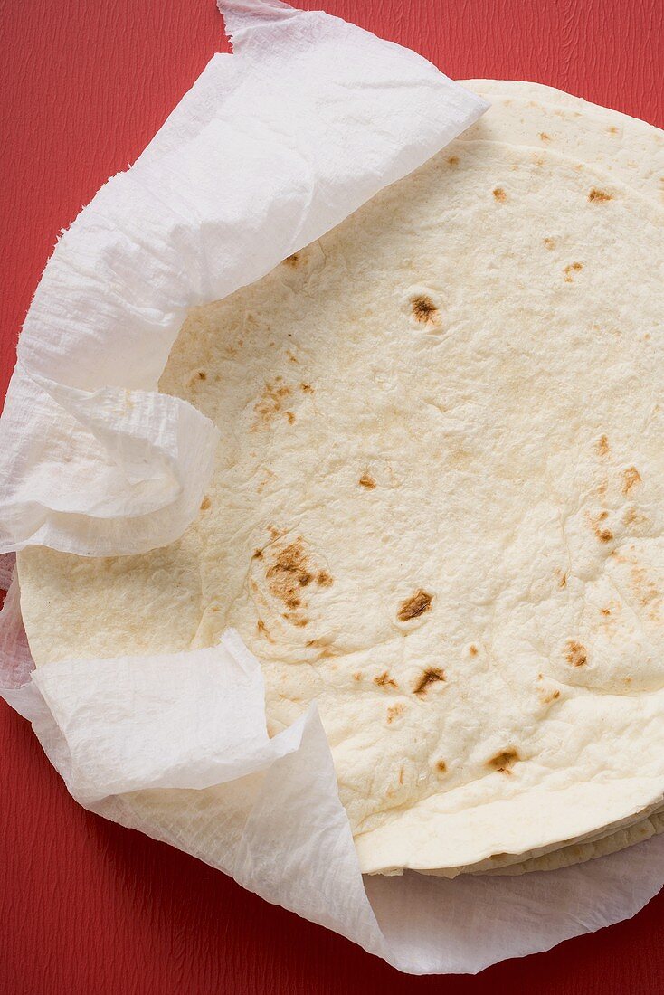 Freshly-baked tortillas on kitchen roll