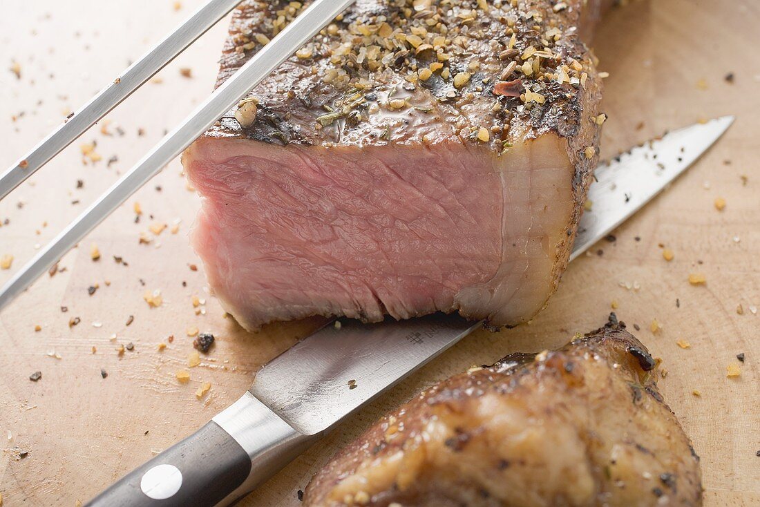 Grilled beef steak, a piece cut off