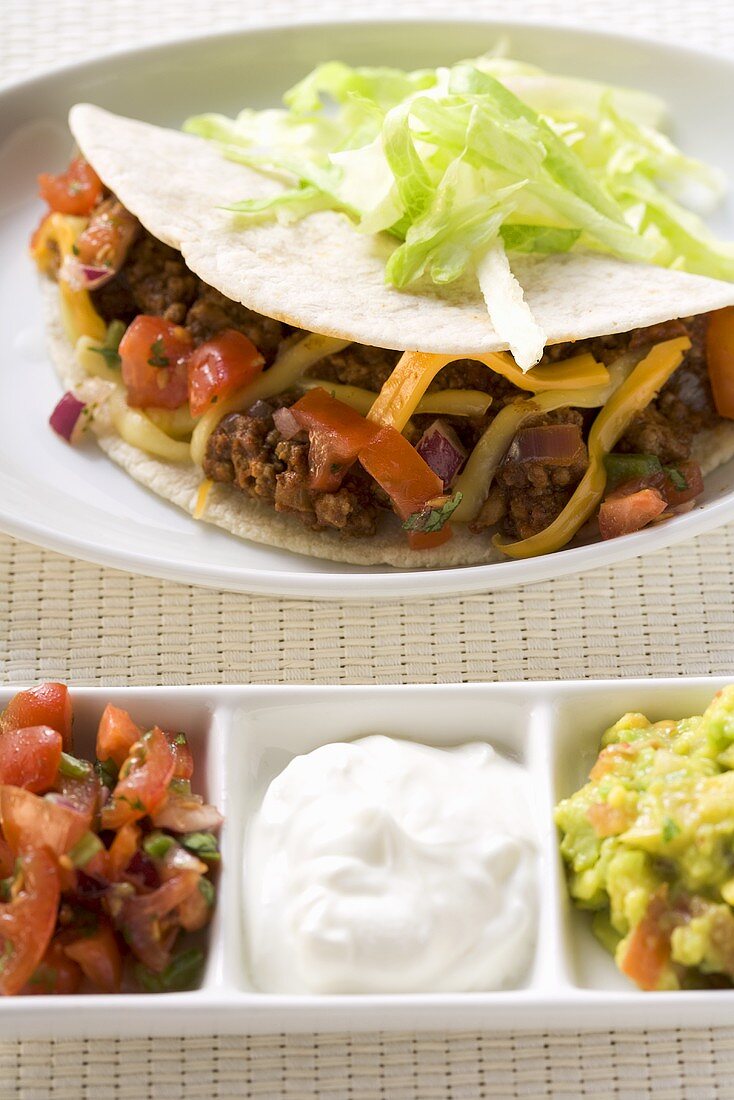 Mince taco with salsa, sour cream, guacamole (Mexico)