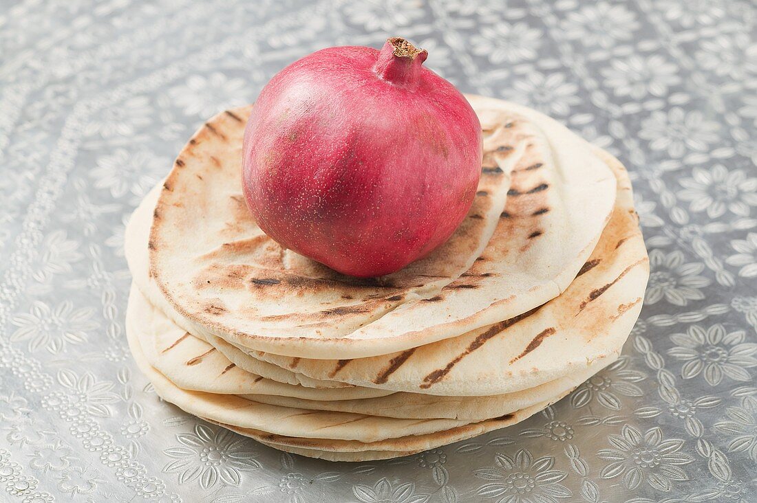 Pomegranate on a stack of flatbread