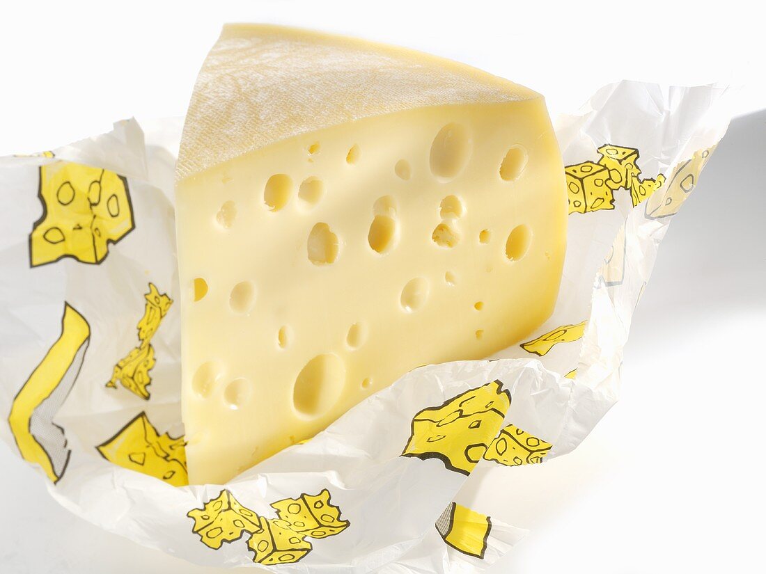 Piece of Emmental cheese in paper