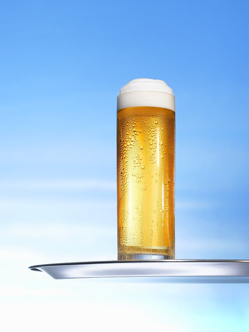 Glass of lager on tray