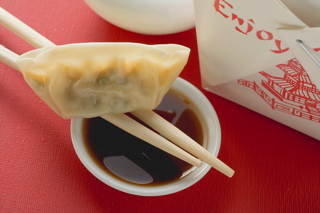 Dim sum with chopsticks and dip to take away (Asia)