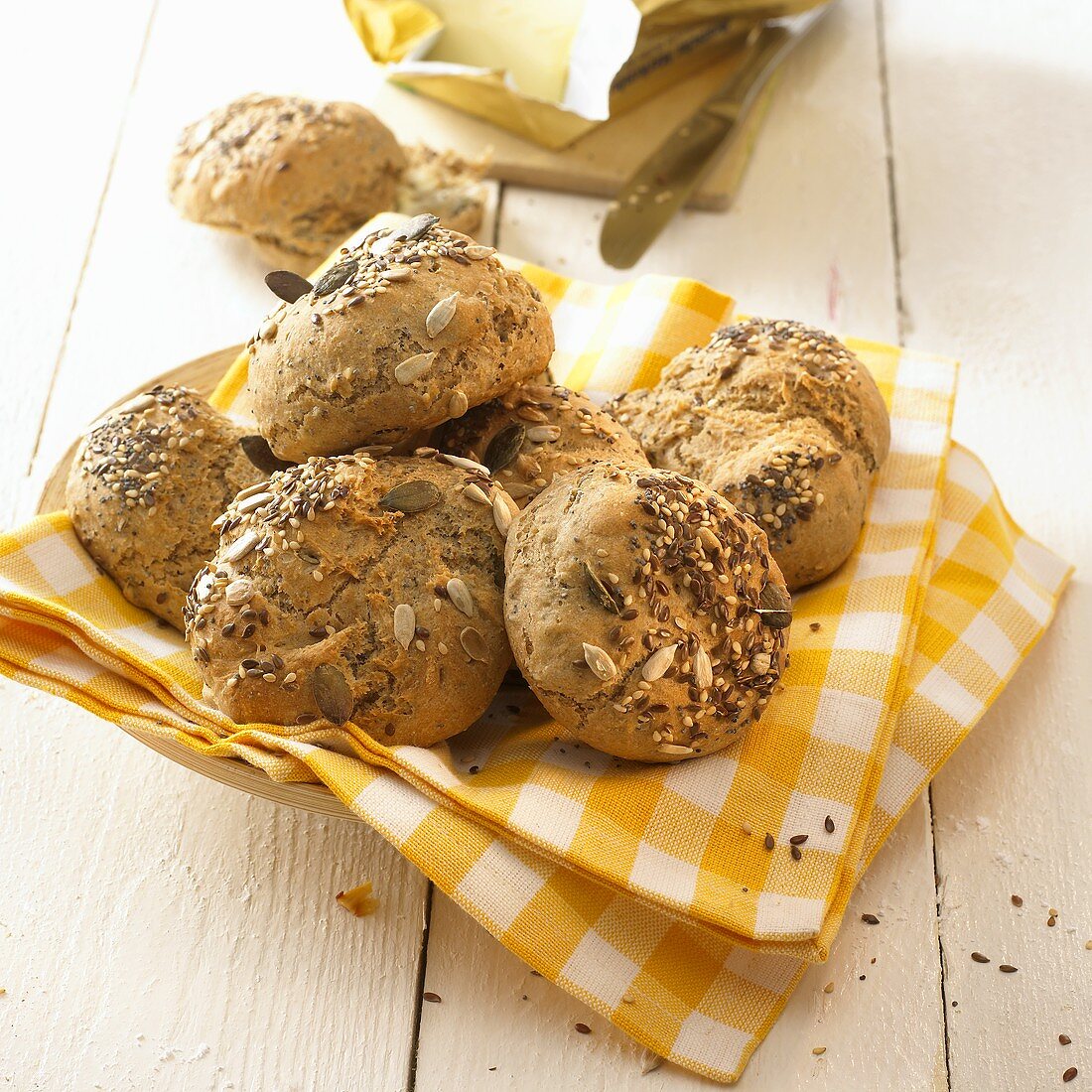 Mixed seed bread rolls on a checked cloth