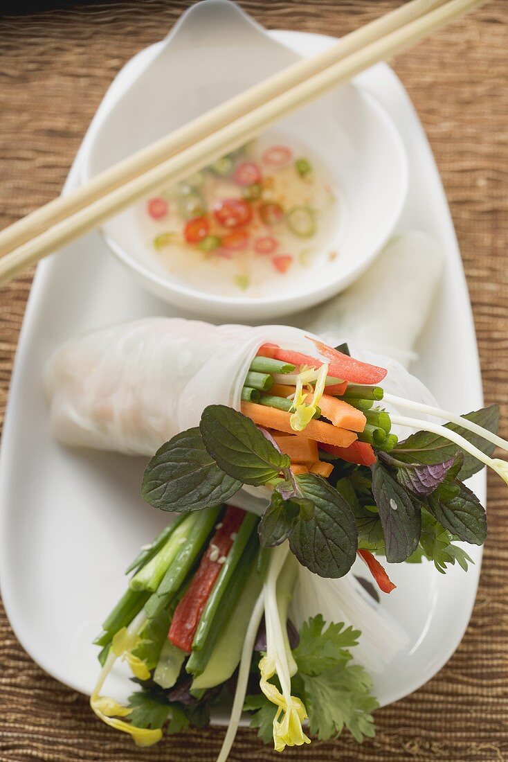 Rice paper roll with vegetable filling and chilli sauce