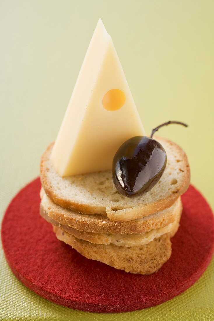 Emmental cheese and olive on slices of white bread