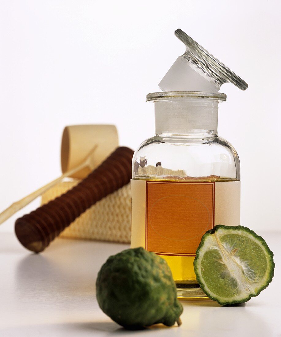Bergamot oil in bottle, massage equipment, kaffir lime