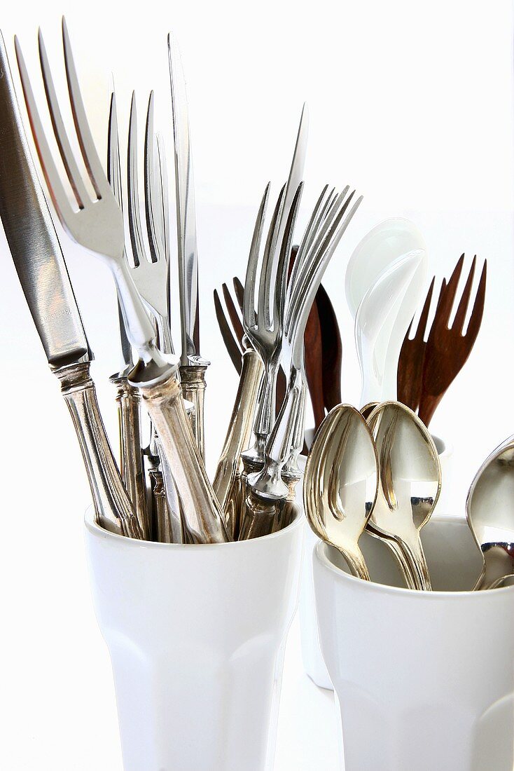 Silver cutlery in coffee beakers