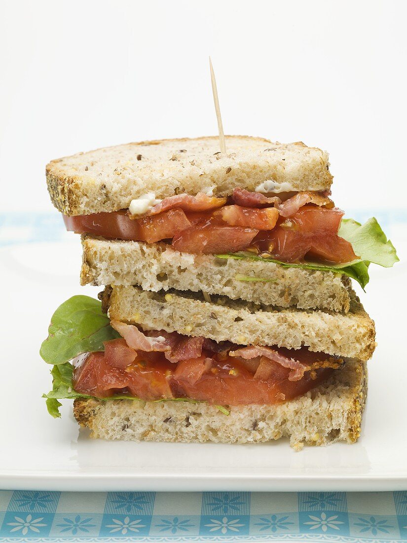 Bacon, lettuce and tomato sandwich, halved and stacked