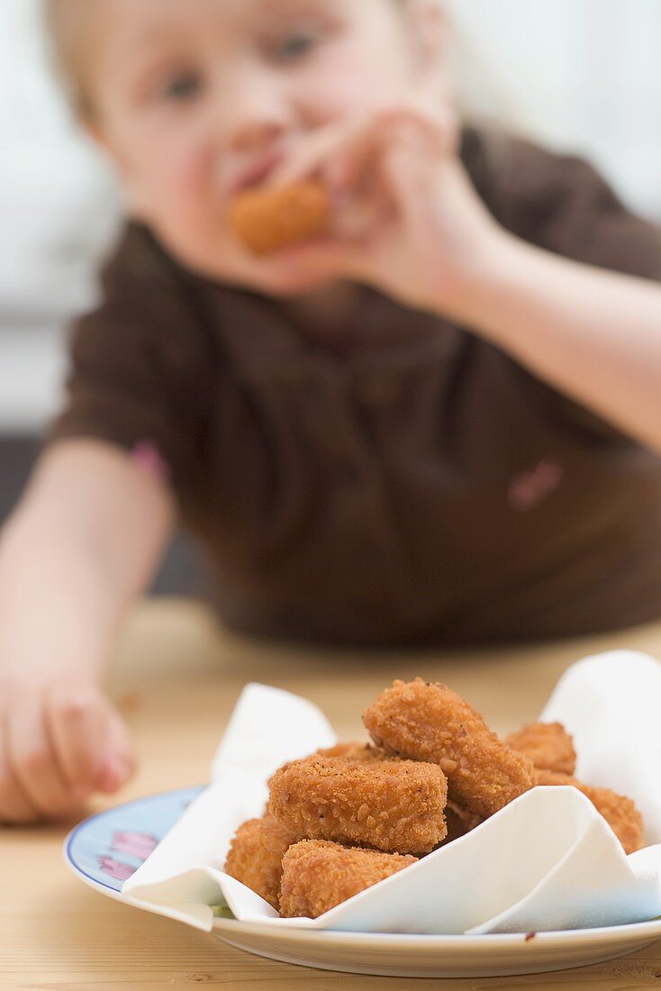 Little girl eating chicken nuggets